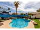 Sparkling pool with tropical mural and waterfall feature, set in landscaped backyard at 1865 E Pinto Dr, Gilbert, AZ 85296