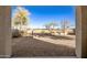 View of the backyard with desert landscaping and block fence at 21487 N Greenway Rd, Maricopa, AZ 85138