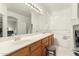 Spacious bathroom features a double sink vanity, large mirror, and a soaking tub for a relaxing experience at 21487 N Greenway Rd, Maricopa, AZ 85138