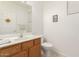 Powder room featuring a wooden vanity and modern fixtures at 21487 N Greenway Rd, Maricopa, AZ 85138