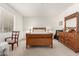 Bright bedroom featuring a wooden sleigh bed, coordinating dresser, and natural light from the window at 21487 N Greenway Rd, Maricopa, AZ 85138