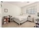 Bright bedroom features a white bed, coordinated dresser, and natural light from the window, creating a peaceful retreat at 21487 N Greenway Rd, Maricopa, AZ 85138