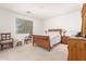 Cozy bedroom with a wooden sleigh bed, complemented by matching nightstands and dresser against white walls at 21487 N Greenway Rd, Maricopa, AZ 85138