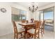 Bright dining room featuring wood table, six chairs, and chandelier at 21487 N Greenway Rd, Maricopa, AZ 85138