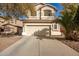 Charming two-story home with a large driveway and desert landscaping at 21487 N Greenway Rd, Maricopa, AZ 85138