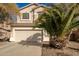 Charming two-story home with a large driveway and desert landscaping at 21487 N Greenway Rd, Maricopa, AZ 85138