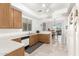 Bright kitchen featuring white countertops, wooden cabinets, and access to dining area at 21487 N Greenway Rd, Maricopa, AZ 85138