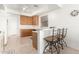 Bright kitchen featuring white countertops, wooden cabinets, and breakfast bar at 21487 N Greenway Rd, Maricopa, AZ 85138