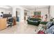 Bright living room featuring tile floors, an office space, and chandelier at 21487 N Greenway Rd, Maricopa, AZ 85138