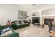 Bright living room featuring tile floors, fireplace, and comfortable sofa at 21487 N Greenway Rd, Maricopa, AZ 85138