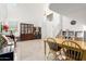 A bright living room with tile floors, a wooden dining table, and a china cabinet at 21487 N Greenway Rd, Maricopa, AZ 85138