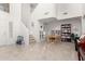 Bright living room featuring tile floors, stairway and a decorative book shelf at 21487 N Greenway Rd, Maricopa, AZ 85138