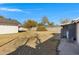 A spacious backyard features drought-tolerant landscaping and fencing, offering privacy at 215 N Hobson --, Mesa, AZ 85203