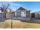 A gray building with French doors stands in a large backyard, surrounded by green grass, perfect for outdoor living at 215 N Hobson --, Mesa, AZ 85203