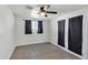 Bedroom with tile floor, ceiling fan, a large window, and sliding glass doors with curtains at 215 N Hobson --, Mesa, AZ 85203