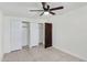 Neutral bedroom with tile floors, a ceiling fan, a small window, and large closets at 215 N Hobson --, Mesa, AZ 85203