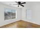 Bright bedroom with hardwood floors, a ceiling fan, and two bright windows at 215 N Hobson --, Mesa, AZ 85203