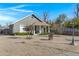 Charming grey home featuring a covered front porch, complemented by a well-maintained yard at 215 N Hobson --, Mesa, AZ 85203