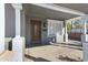 Inviting front porch showcasing a classic wood door, a window, and sturdy support columns at 215 N Hobson --, Mesa, AZ 85203