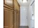 Hallway featuring ample wood cabinets with brushed bronze hardware and a white door at 215 N Hobson --, Mesa, AZ 85203