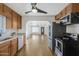 Galley kitchen featuring stainless steel appliances and white subway tile backsplash with an open view to the living room at 215 N Hobson --, Mesa, AZ 85203