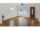 Bright living room with hardwood floors, a ceiling fan, and a classic wood door at 215 N Hobson --, Mesa, AZ 85203