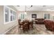 View of the dining room featuring shutters, a wooden table and leather furniture at 21919 N Bradford Dr, Maricopa, AZ 85138