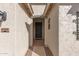 View of the entrance to a home featuring a dark-colored front door and decorative accents at 21919 N Bradford Dr, Maricopa, AZ 85138