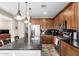 Kitchen featuring stainless steel appliances, granite countertops, and wood cabinets at 21919 N Bradford Dr, Maricopa, AZ 85138