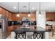 Kitchen featuring stainless steel appliances, a center island, and wood cabinets at 21919 N Bradford Dr, Maricopa, AZ 85138