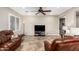 A welcoming living room featuring tile floors, neutral walls, and comfortable leather furniture at 21919 N Bradford Dr, Maricopa, AZ 85138