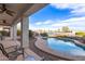 Covered patio with outdoor furniture overlooking pool and water view at 21919 N Bradford Dr, Maricopa, AZ 85138