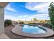 Sparkling pool with well-maintained desert landscaping and views of the lake at 21919 N Bradford Dr, Maricopa, AZ 85138