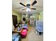 Living room with neutral-colored tiled flooring, a ceiling fan, bright green walls, and ample space at 2201 N 35Th Dr, Phoenix, AZ 85009