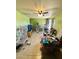 Living room with neutral-colored tiled flooring, a ceiling fan, and bright green walls at 2201 N 35Th Dr, Phoenix, AZ 85009