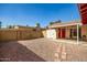 Exterior view of the house with a desert landscaped backyard, patio and block fence at 2205 E Linda Ct, Phoenix, AZ 85022