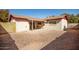 Exterior view of the house with a covered patio and a desert landscaped backyard at 2205 E Linda Ct, Phoenix, AZ 85022