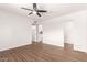 A clean, empty bedroom featuring a ceiling fan, wood floors, and light-colored walls at 2205 E Linda Ct, Phoenix, AZ 85022