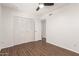 A bedroom featuring a wood-look floor, closet, ceiling fan and a doorway to another room at 2205 E Linda Ct, Phoenix, AZ 85022