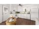 This kitchen features white cabinetry and appliances, dark wood floors, and modern fixtures at 2205 E Linda Ct, Phoenix, AZ 85022