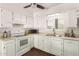 Bright kitchen featuring white cabinets and appliances, wood flooring, and plenty of counter space at 2205 E Linda Ct, Phoenix, AZ 85022