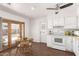 Bright kitchen with white cabinetry, modern appliances, a ceiling fan, and a charming breakfast nook at 2205 E Linda Ct, Phoenix, AZ 85022