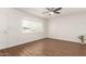 Bright living room with wood-look floors, ceiling fan, and a large window at 2205 E Linda Ct, Phoenix, AZ 85022