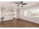 Open-concept living area with wood-look floors, ceiling fan, and seamless access to the kitchen at 2205 E Linda Ct, Phoenix, AZ 85022