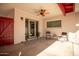 Covered patio with plants, chairs, and a view into the house through sliding glass doors at 2205 E Linda Ct, Phoenix, AZ 85022