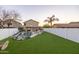 Beautiful backyard with a pebble-tec pool, artificial turf, and private fencing at 2226 E Parkside Ln, Phoenix, AZ 85024