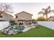 Inviting backyard oasis with a sparkling pool, lush green lawn, and comfortable lounge area perfect for relaxation and entertaining at 2226 E Parkside Ln, Phoenix, AZ 85024