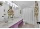 Bright bathroom featuring a giraffe accent wall, white cabinets and hardwood floors at 2226 E Parkside Ln, Phoenix, AZ 85024