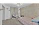 Bright bedroom featuring neutral carpet, floral accent wall and a modern light fixture at 2226 E Parkside Ln, Phoenix, AZ 85024