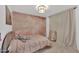 Stylish bedroom featuring gray carpet, modern light fixture and pink accent wall at 2226 E Parkside Ln, Phoenix, AZ 85024